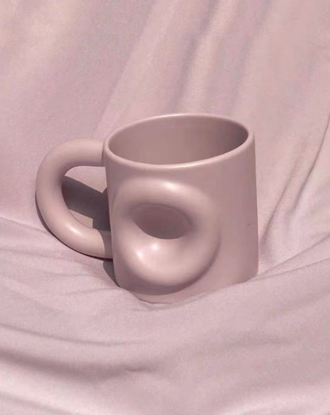 Handcrafted Ceramic Donut Mug in various colors, showcasing its unique donut shape and high-quality ceramic finish.