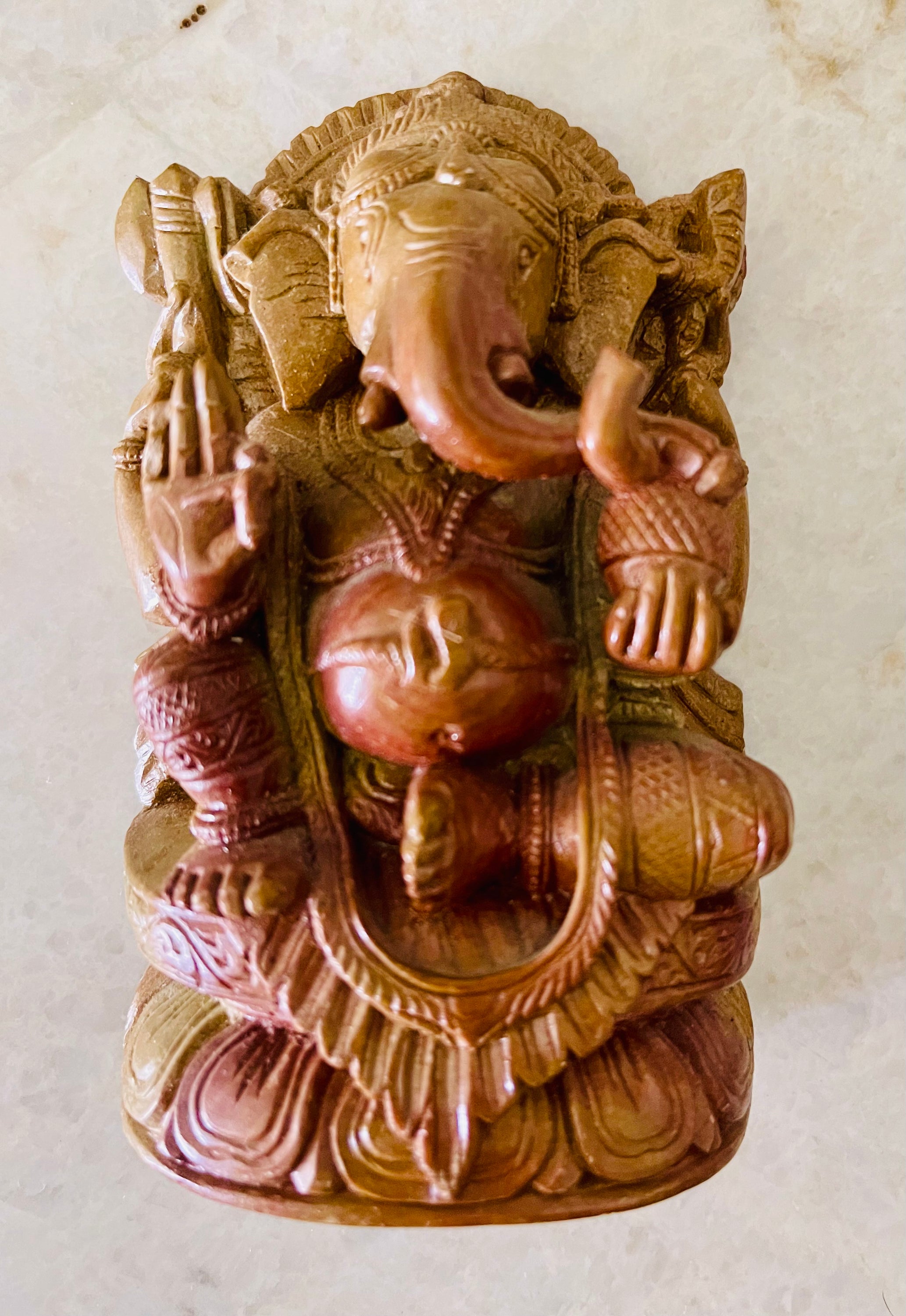 Handcrafted soapstone sculpture of God Ganesha with elephant head, showcasing intricate details and a matte finish.