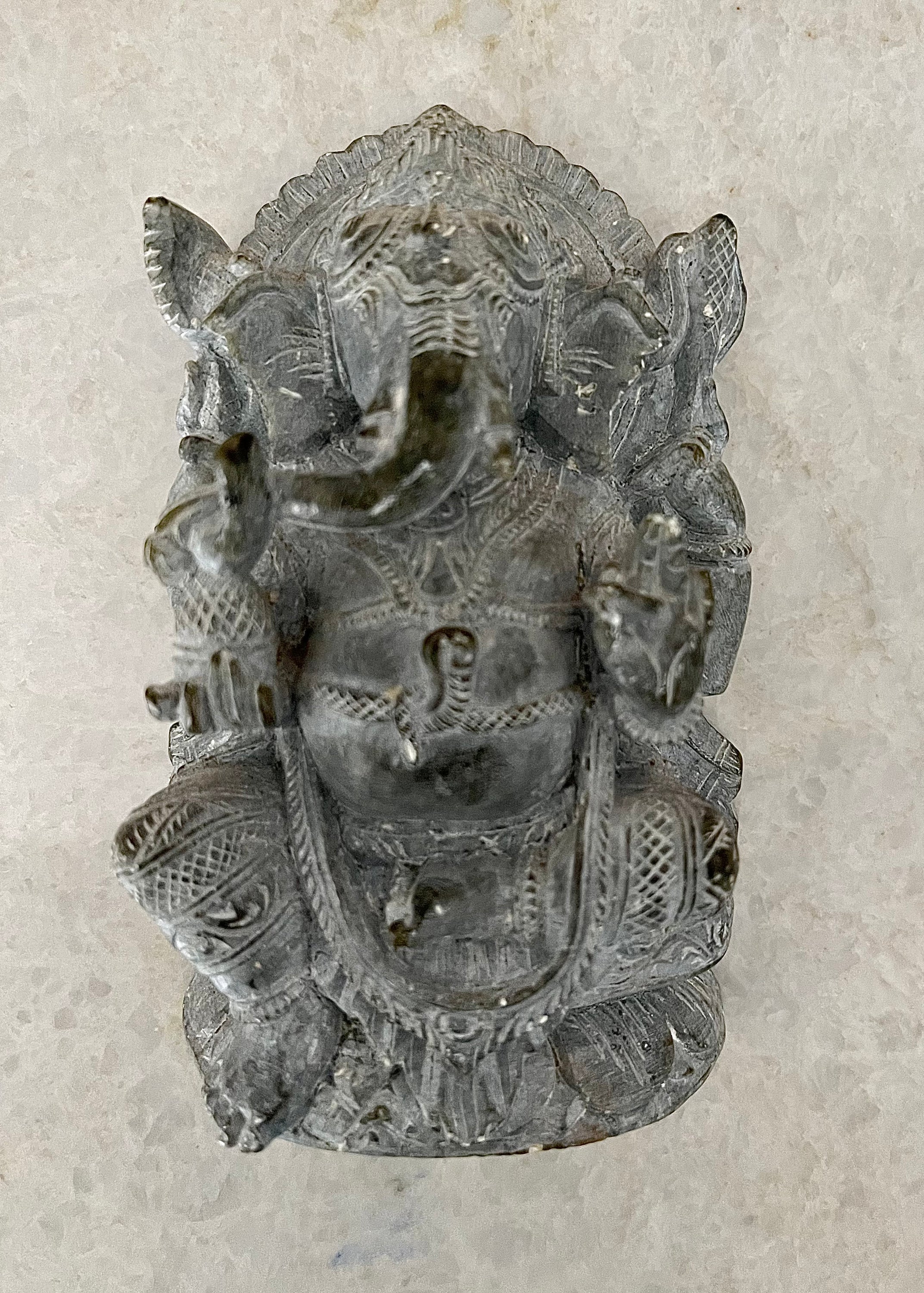 Handcrafted soapstone sculpture of God Ganesha with elephant head, showcasing intricate details and a matte finish.