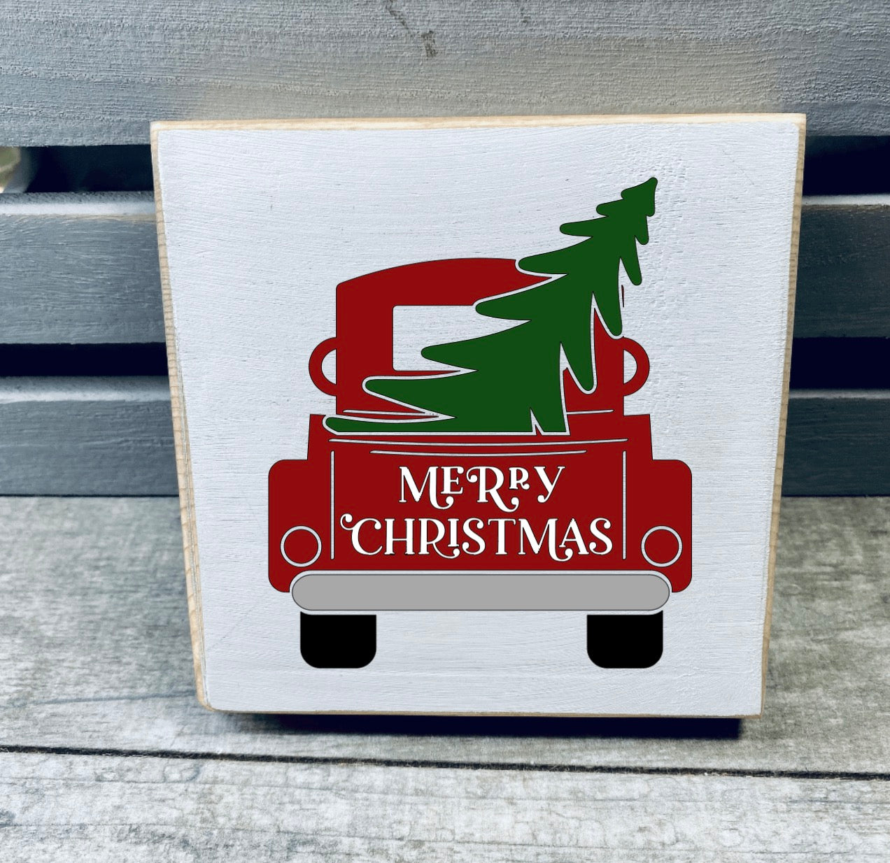 Hand-painted wooden Christmas sign featuring festive design, perfect for tiered trays or shelves, made from solid pine with unique wood grain.