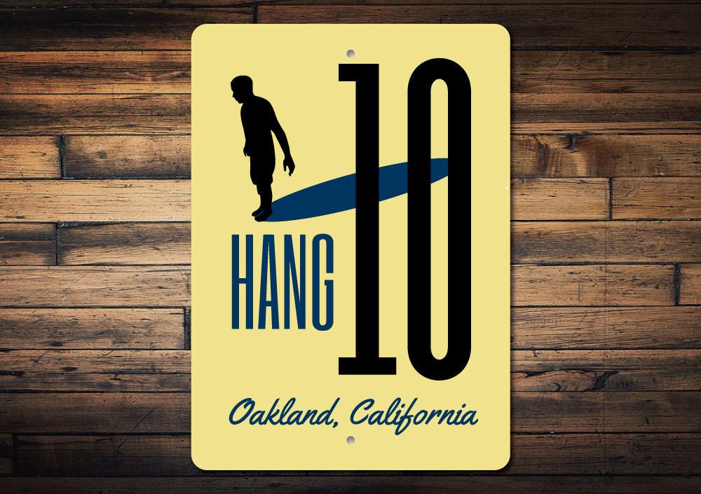 A vibrant Hang Ten Sign made of high-quality aluminum, featuring beach-themed graphics, perfect for coastal decor.