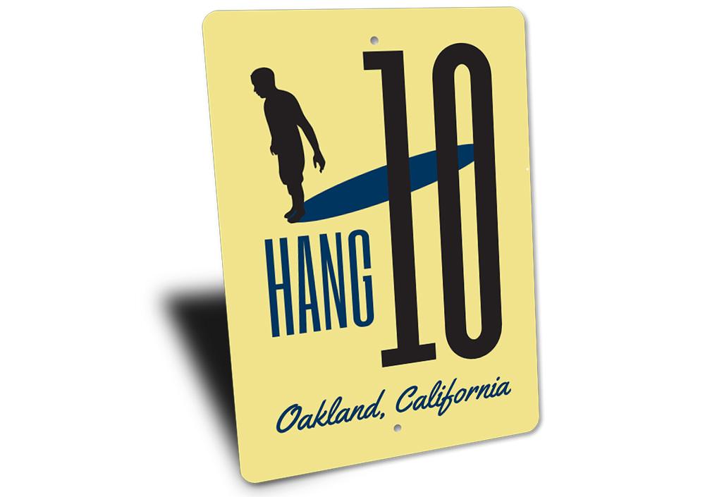 A vibrant Hang Ten Sign made of high-quality aluminum, featuring beach-themed graphics, perfect for coastal decor.