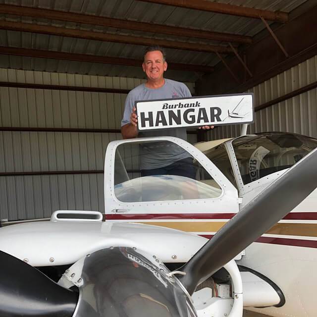 Customizable Hangar Sign made from high-quality aluminum, featuring pre-drilled holes for easy mounting.