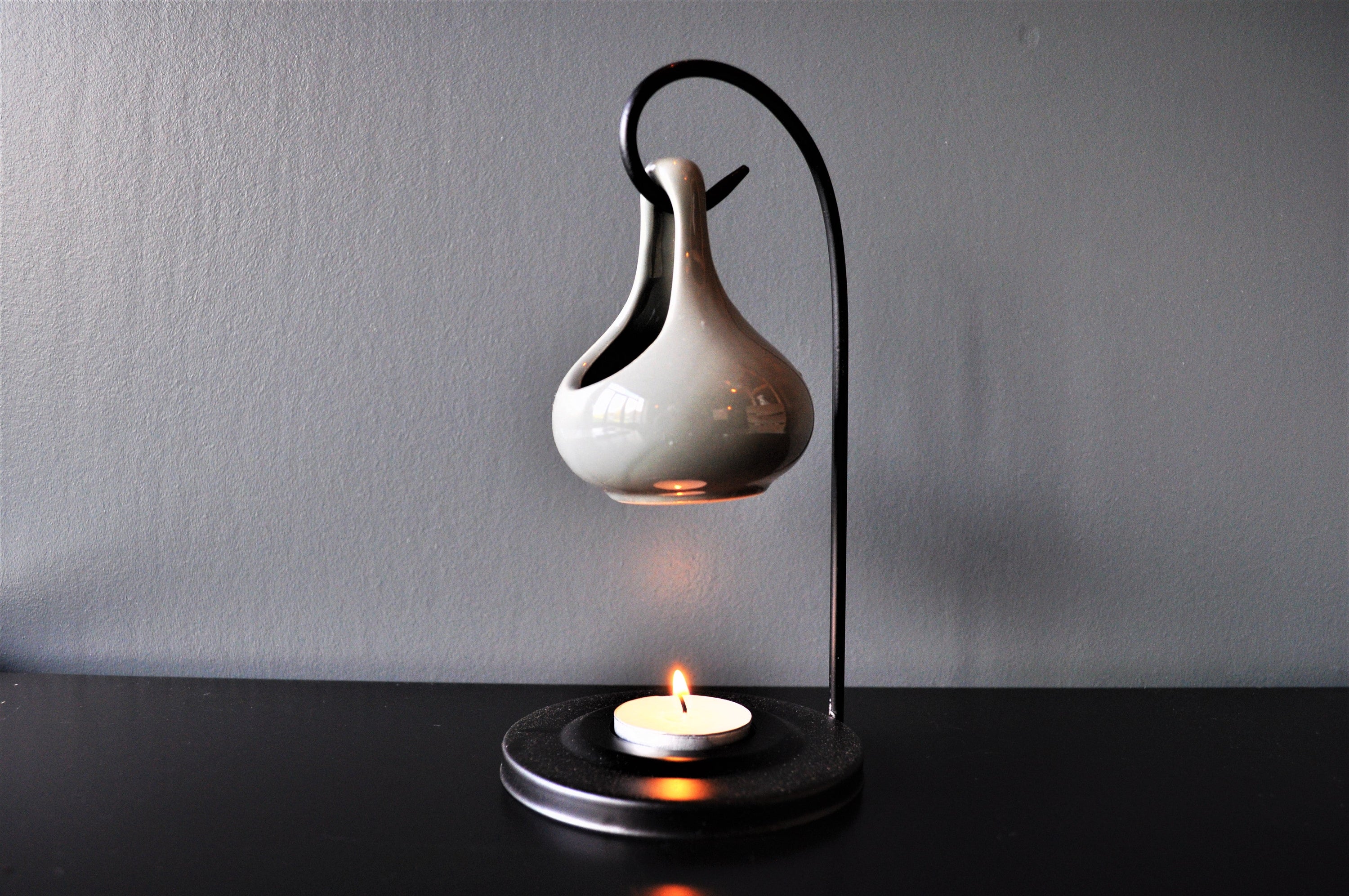 Grey hanging oil wax burner with an industrial black hanger, elegantly designed for home fragrance.