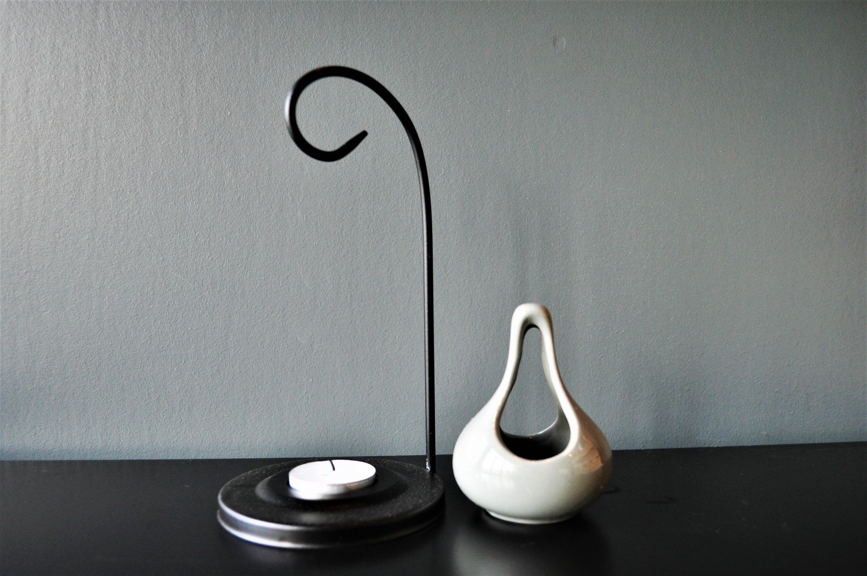 Grey hanging oil wax burner with an industrial black hanger, elegantly designed for home fragrance.