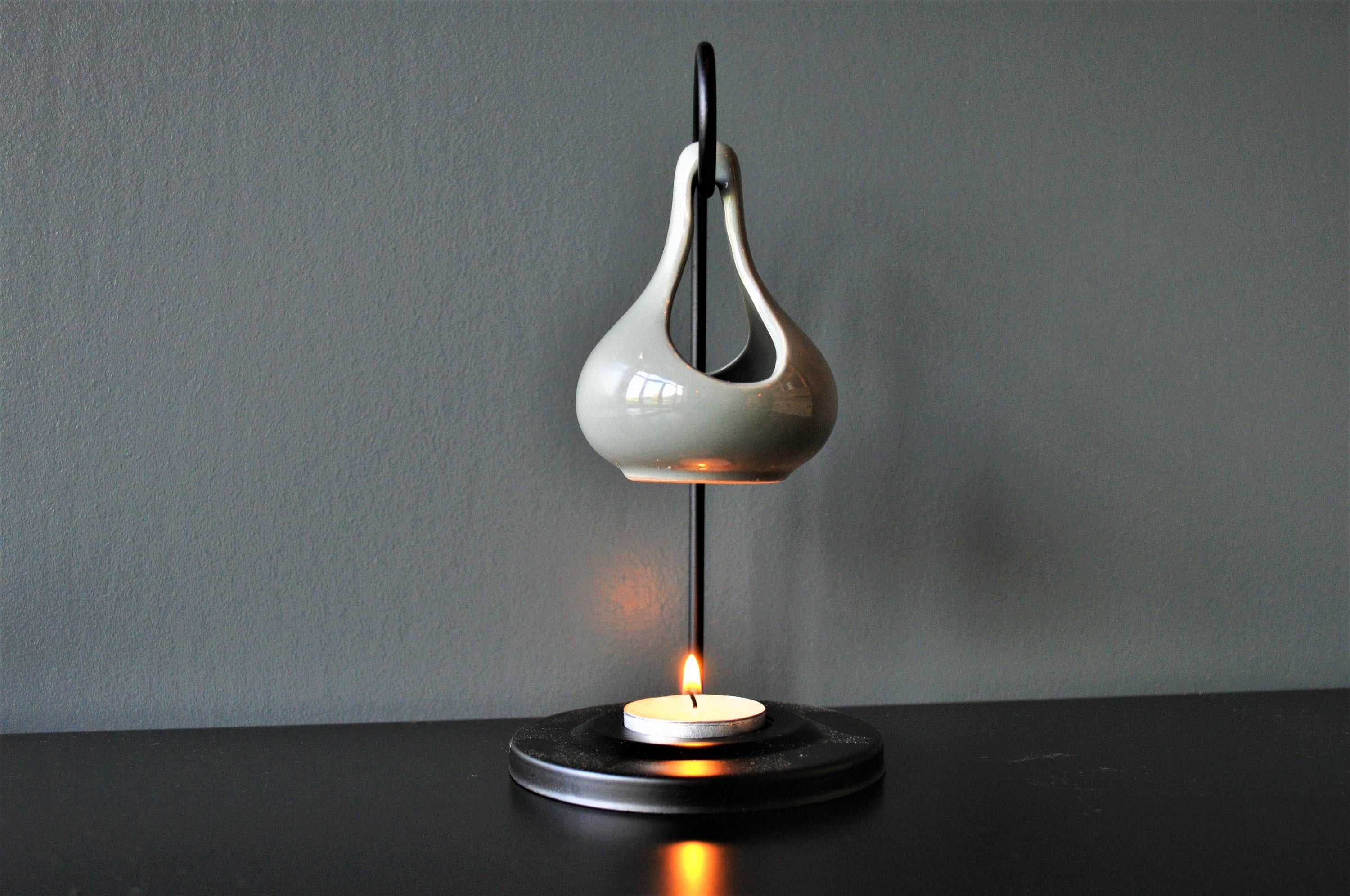 Grey hanging oil wax burner with an industrial black hanger, elegantly designed for home fragrance.