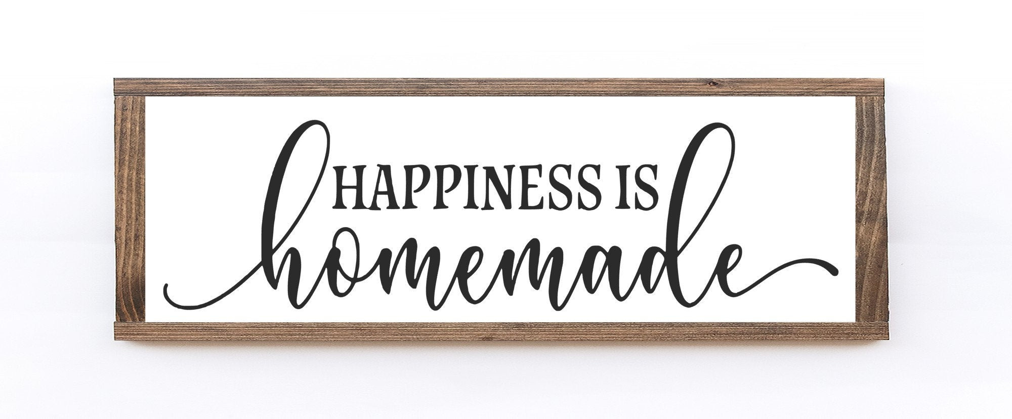 A rustic wood sign that reads 'Happiness is Homemade' in elegant lettering, featuring a matte white background and natural wood grain.