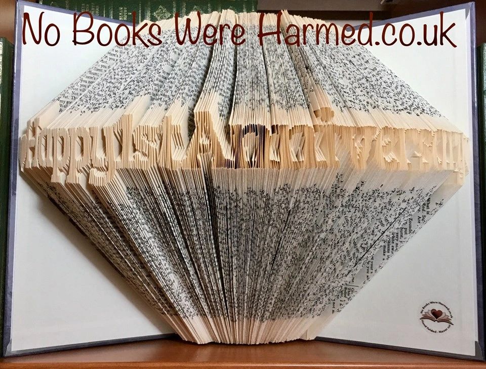 Handcrafted book art celebrating a 1st anniversary, made from vintage books with unique folds and designs.