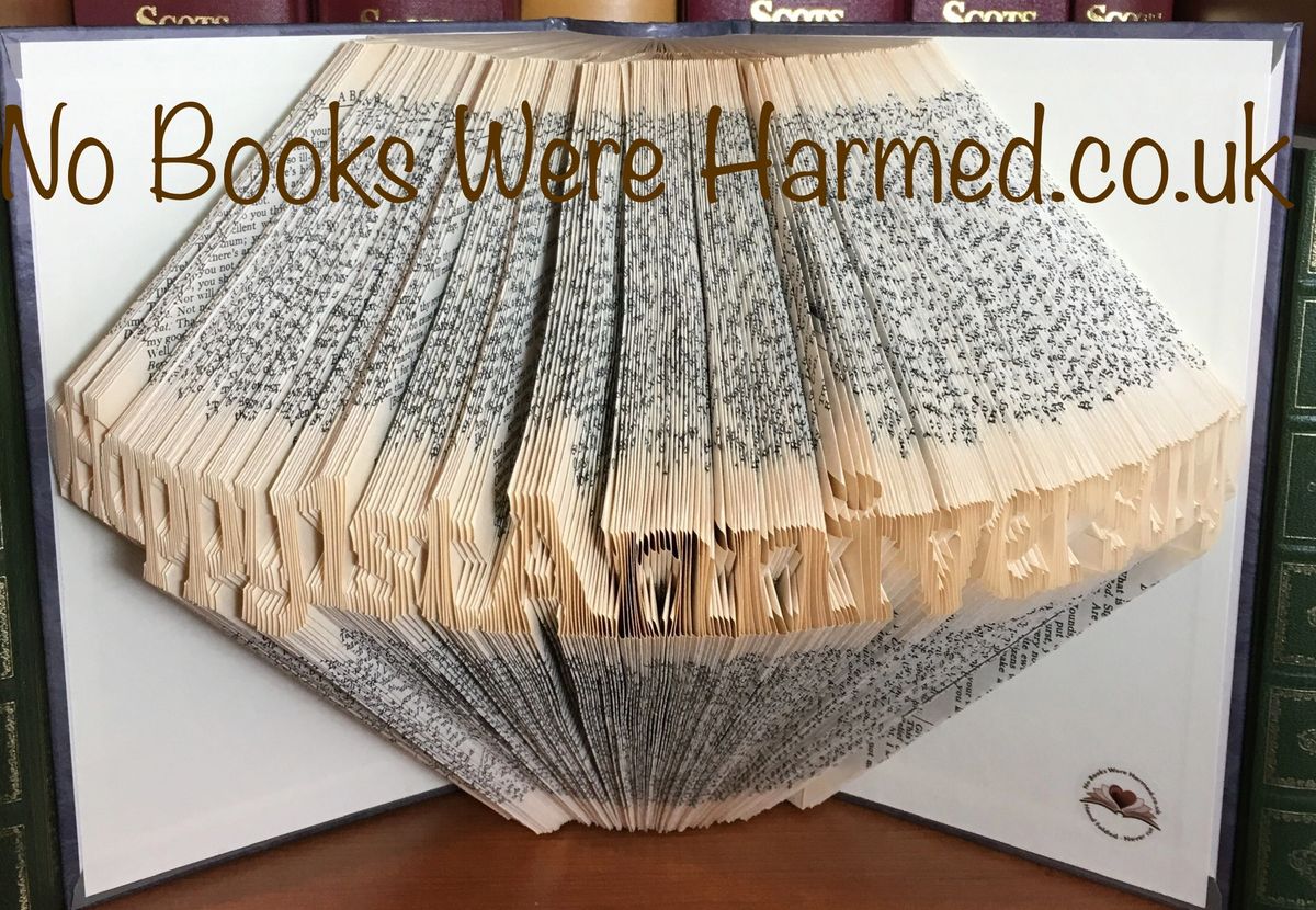 Handcrafted book art celebrating a 1st anniversary, made from vintage books with unique folds and designs.