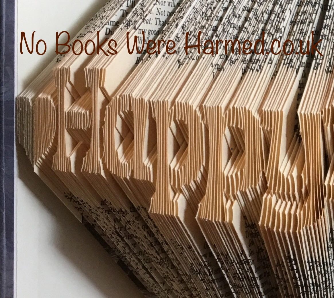 Handcrafted book art celebrating a 1st anniversary, made from vintage books with unique folds and designs.