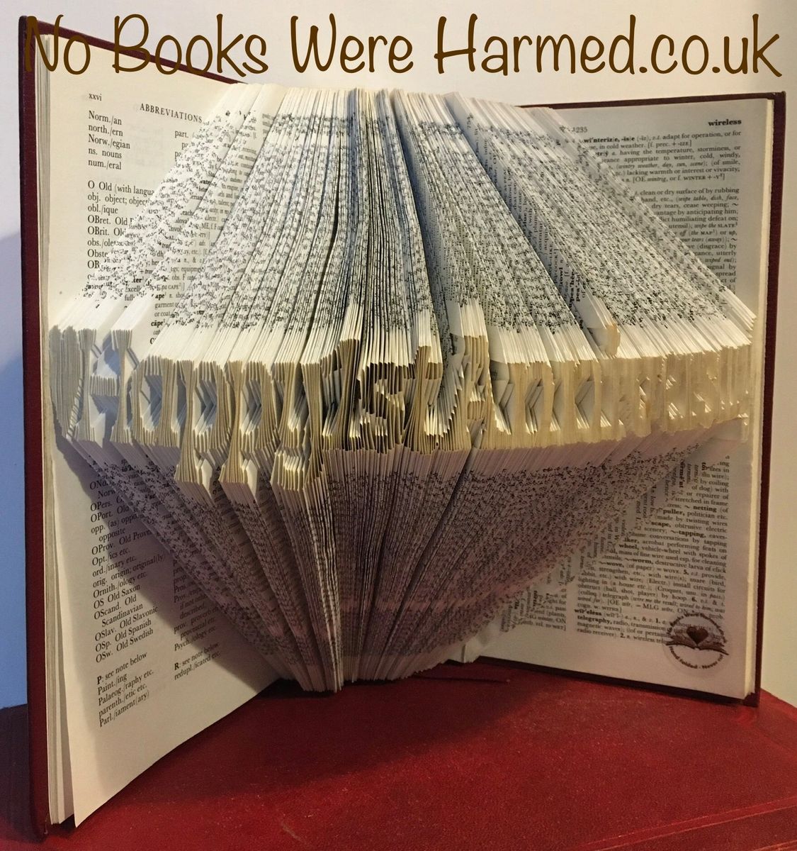 Handcrafted book art celebrating a 1st anniversary, made from vintage books with unique folds and designs.