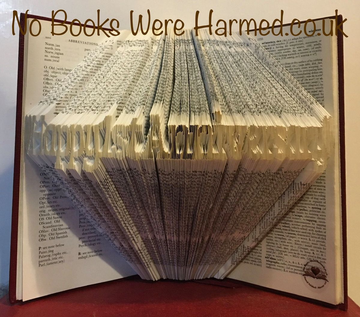 Handcrafted book art celebrating a 1st anniversary, made from vintage books with unique folds and designs.