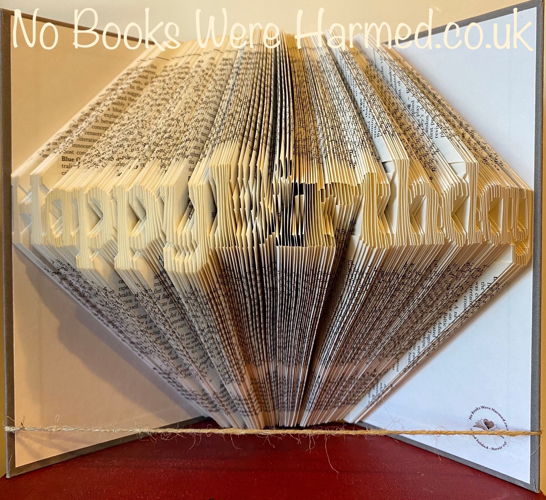 Handcrafted Happy Birthday book art made from vintage books, showcasing intricate folded pages in a unique design.