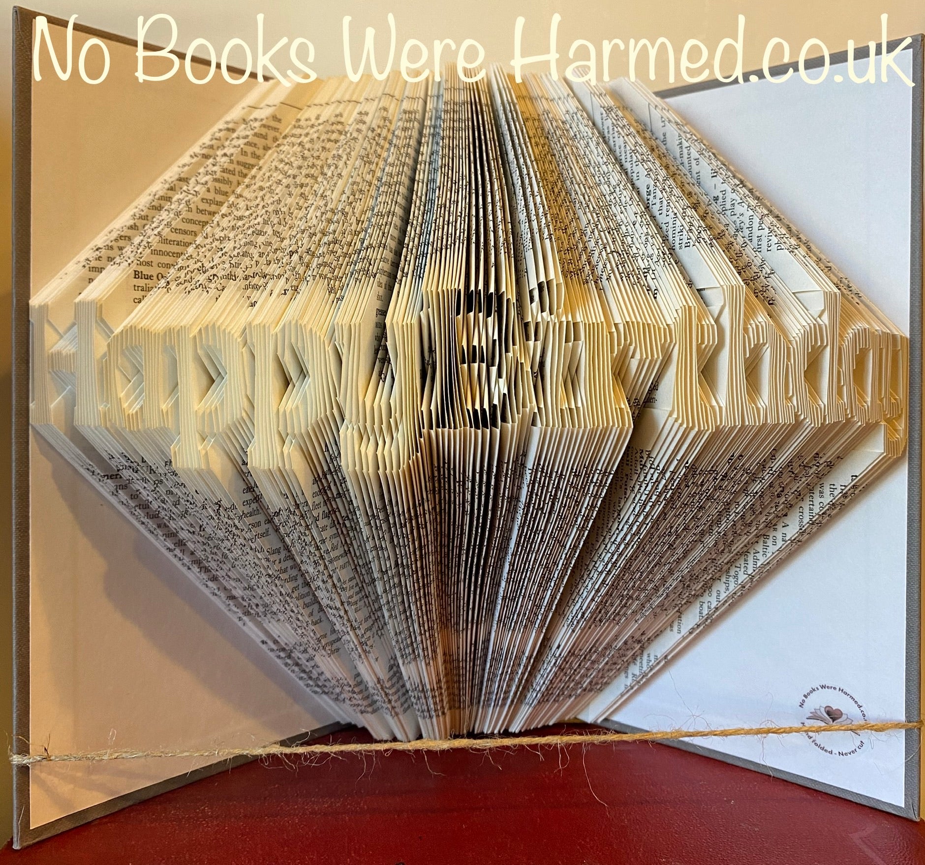 Handcrafted Happy Birthday book art made from vintage books, showcasing intricate folded pages in a unique design.