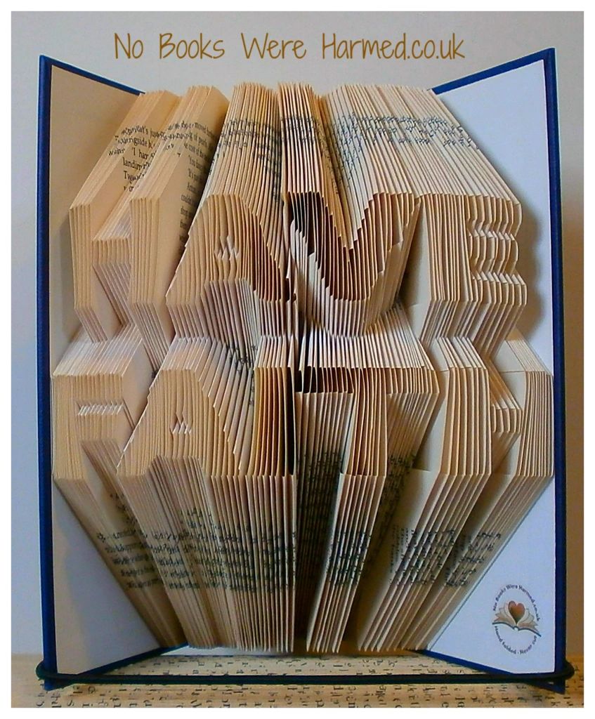 Hand folded book art displaying the words 'HAVE FAITH', crafted from vintage books with intricate page folds.