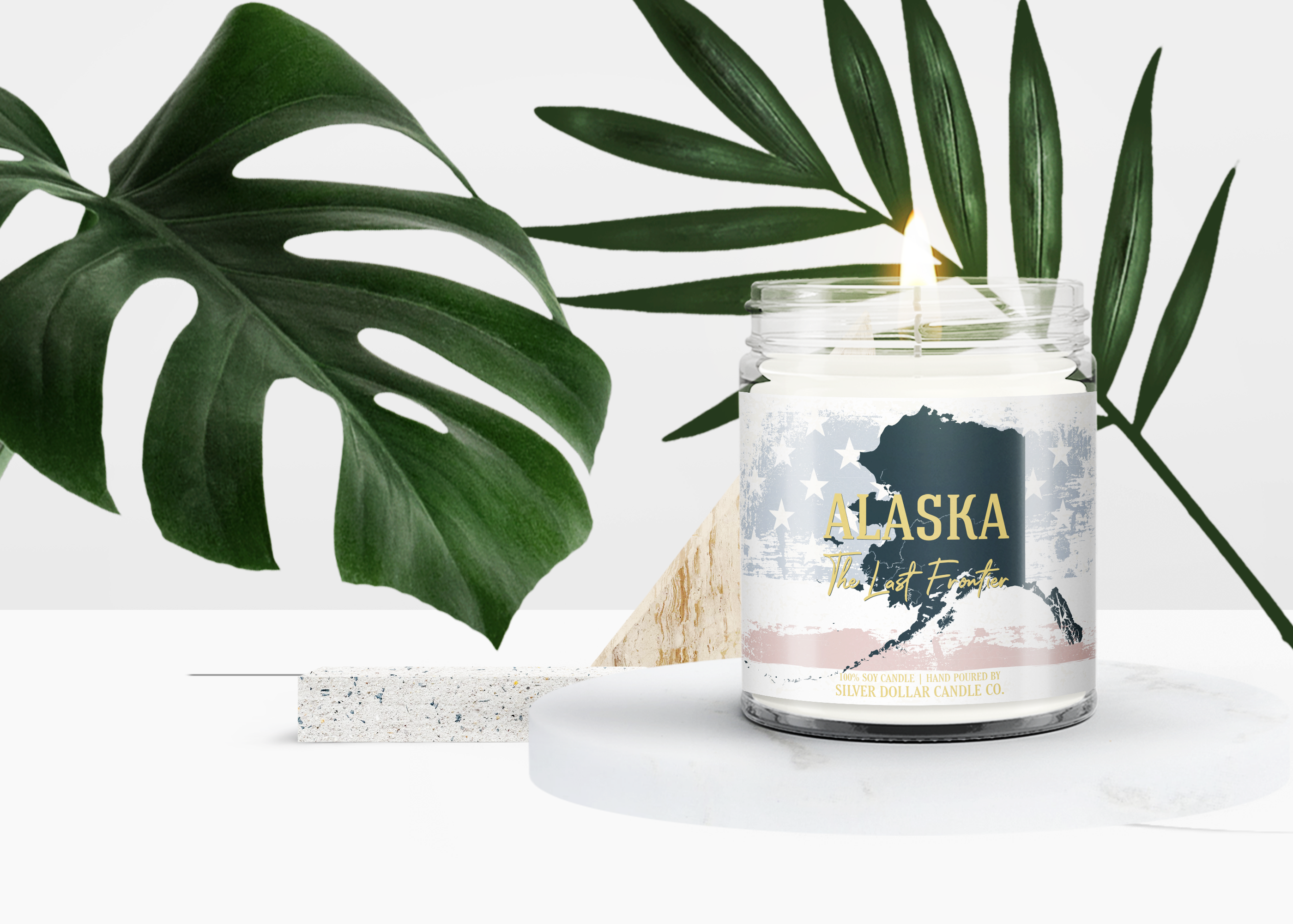 Hawaii State Candle in a decorative box, showcasing its vibrant design and personalized lid option, surrounded by tropical elements.