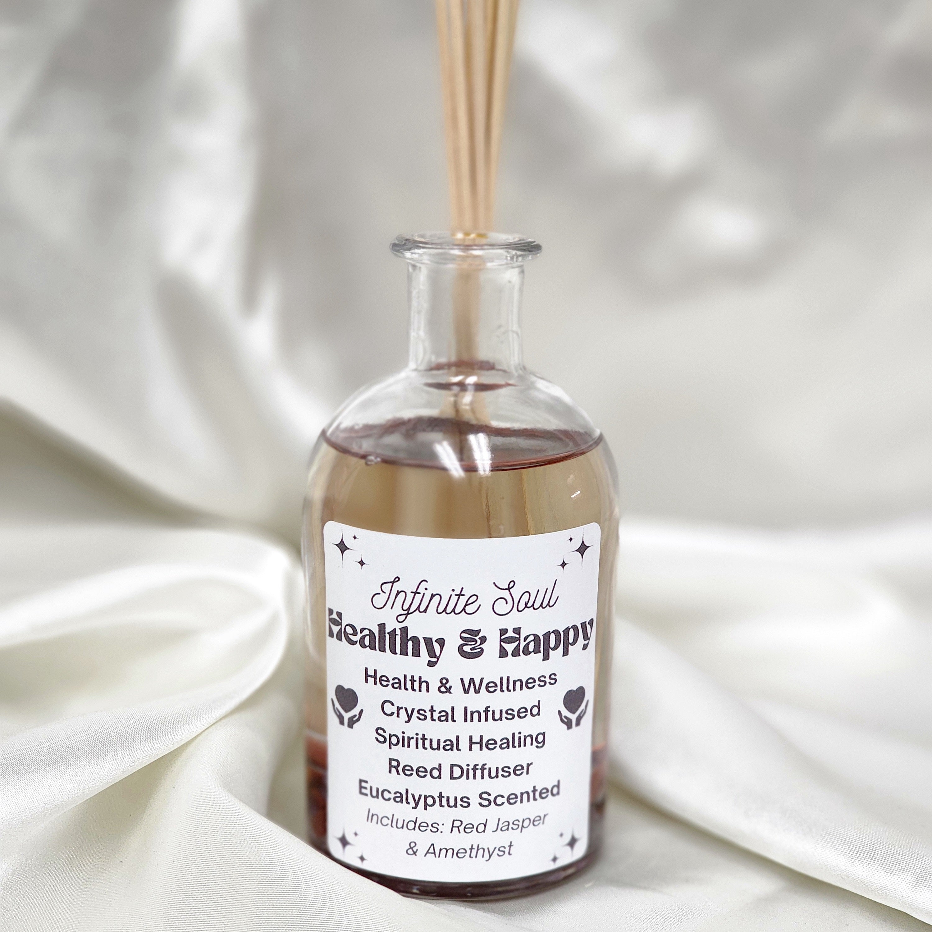 Healthy & Happy Crystal Infused Reed Diffuser featuring Citrine and Amethyst in a stylish glass bottle with natural reeds.