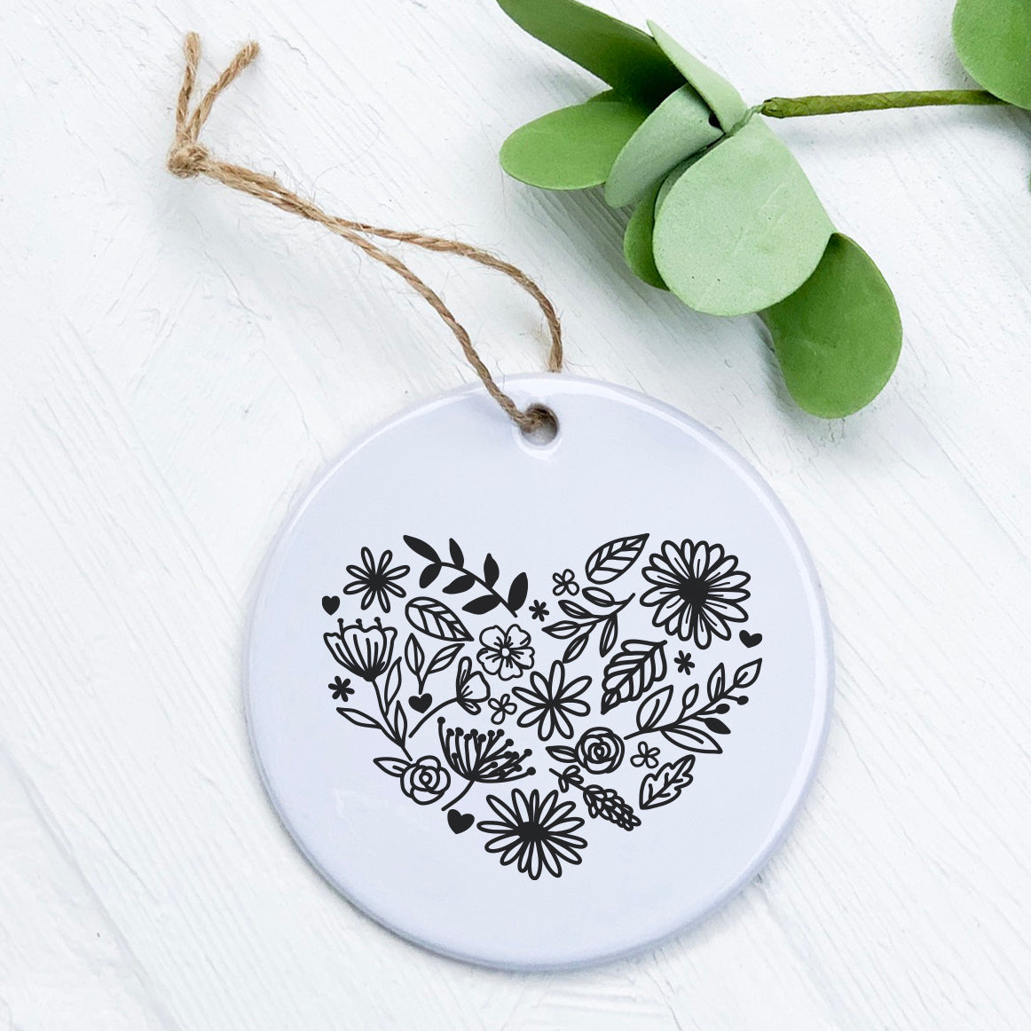 Heart of Flowers Ornament made of high-quality porcelain with a vibrant floral design, measuring 2.75 inches in diameter.