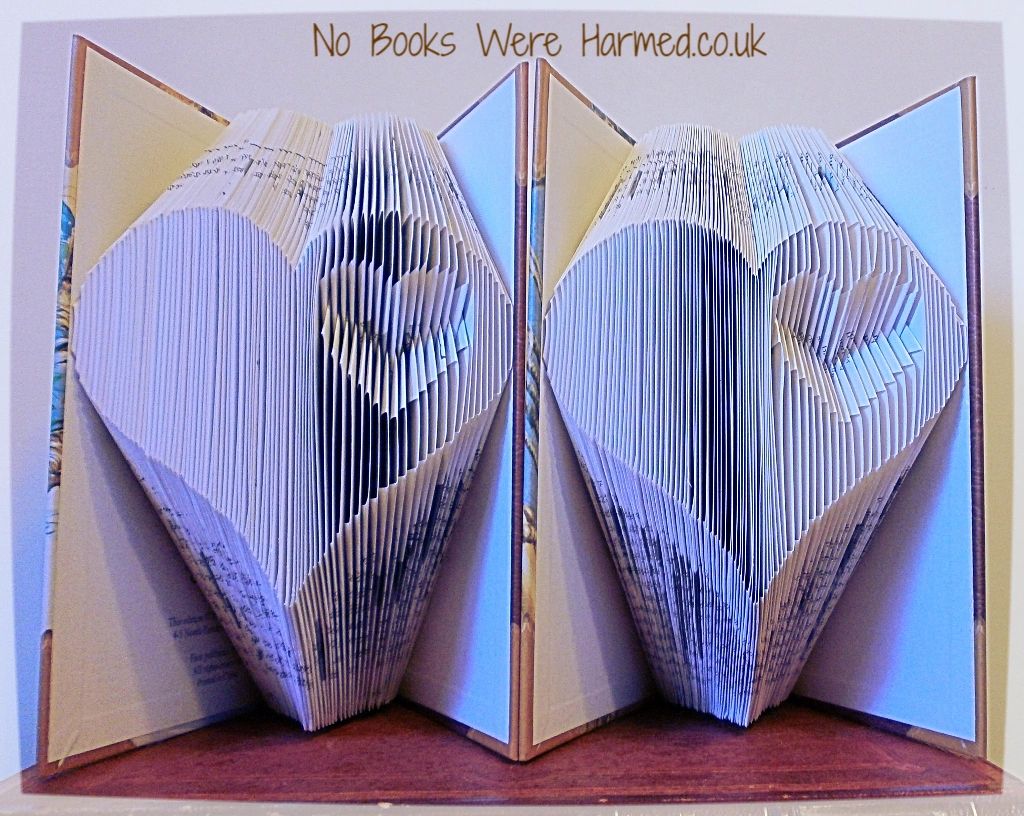 Handcrafted Heart within a Heart art piece made from vintage book pages, showcasing intricate folds and unique design.