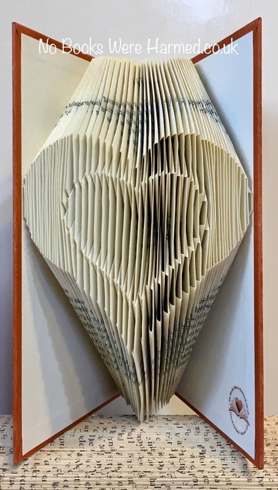 Handcrafted Heart within Heart art made from vintage book pages, showcasing intricate folds and unique design.