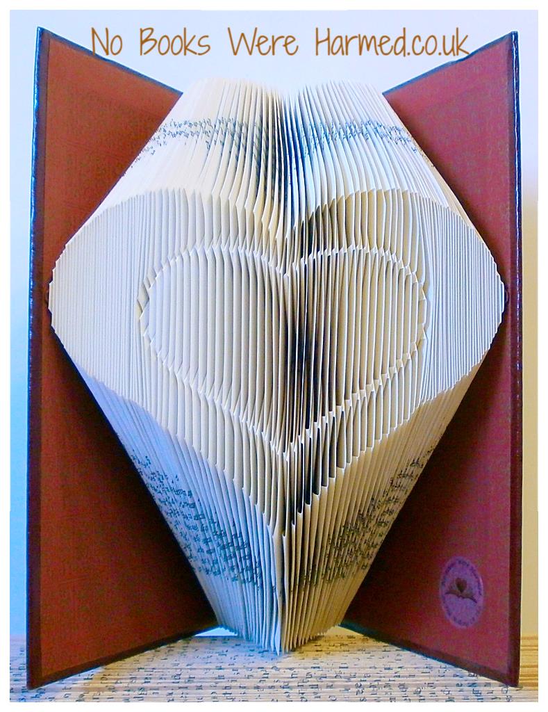 Handcrafted Heart within Heart art made from vintage book pages, showcasing intricate folds and unique design.