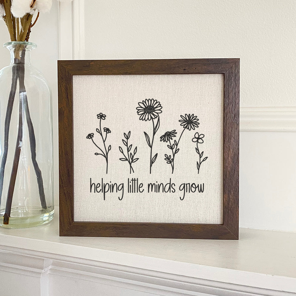 Helping Little Minds Grow framed sign with a wood frame and linen-look background, perfect for children's rooms.