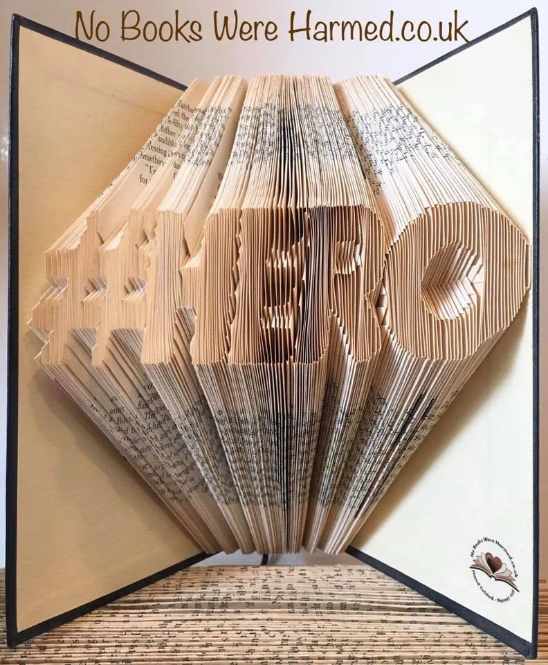 Unique #HERO book art handcrafted from vintage books, showcasing intricate hand-folded designs.