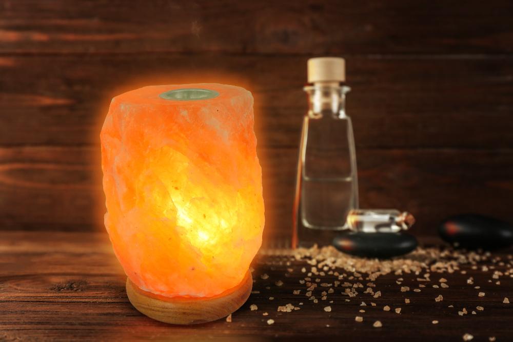 Himalayan Natural Aroma Rock Salt Lamp with a warm amber glow, hand-carved from pure Himalayan salt, resting on a polished wooden base.