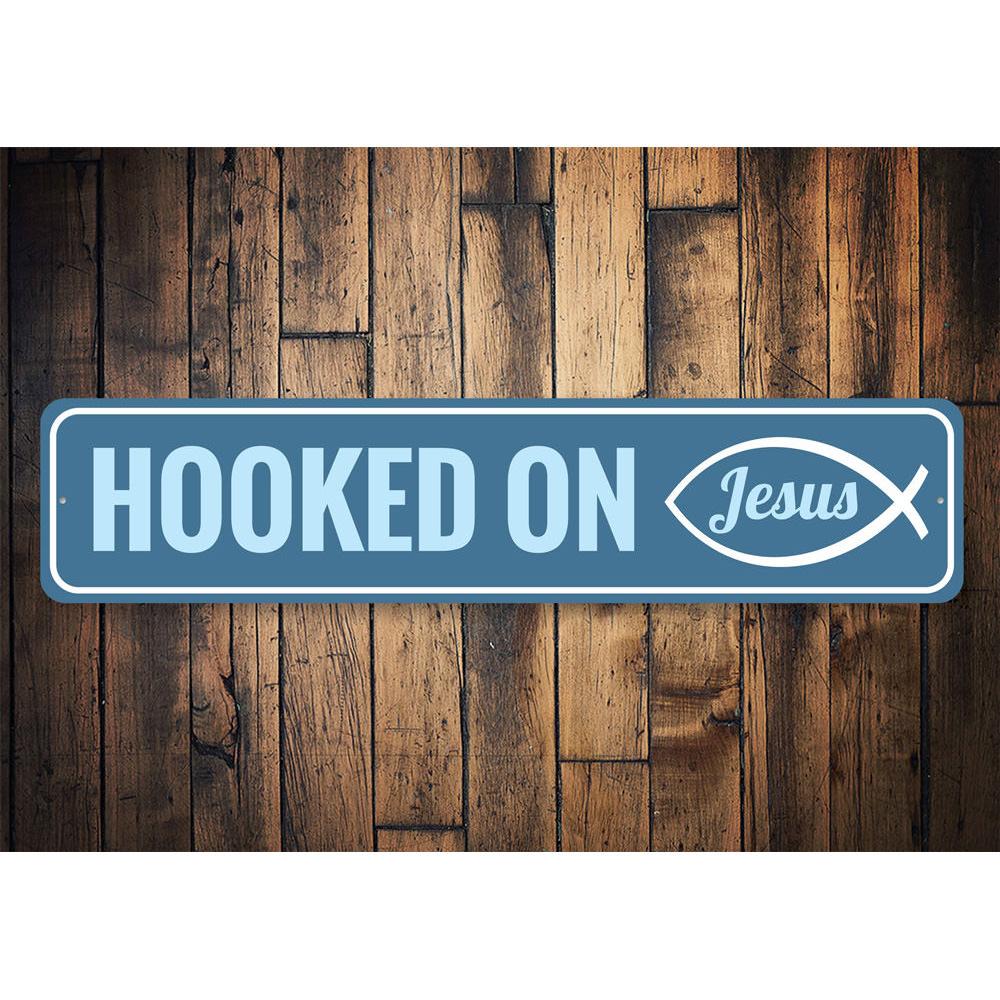 A decorative Hooked on Jesus Sign made of high-quality aluminum, featuring a beautiful design that adds a spiritual touch to any room.