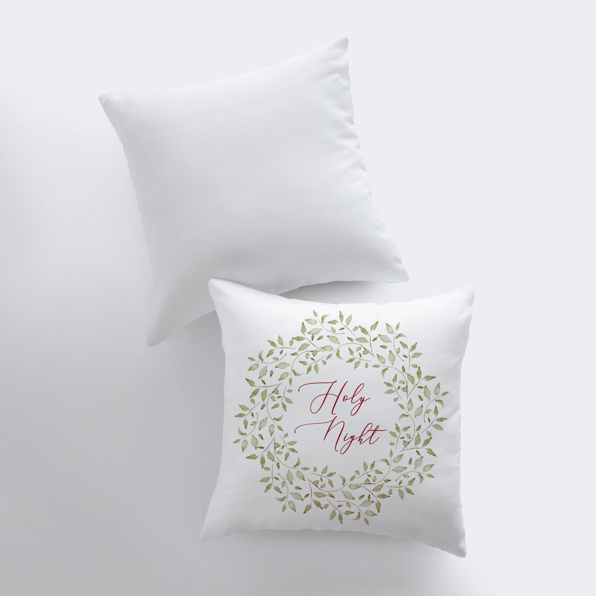 Holy Night Leaf Wreath Throw Pillow featuring red cursive text and eucalyptus wreath design on a white background.