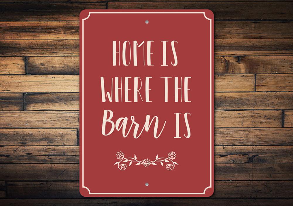 A decorative metal sign reading 'Home is Where the Barn is', showcasing a rustic design suitable for barns and farmhouses.