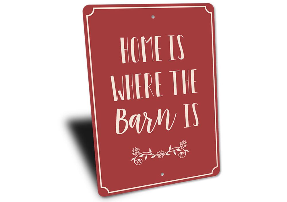 A decorative metal sign reading 'Home is Where the Barn is', showcasing a rustic design suitable for barns and farmhouses.