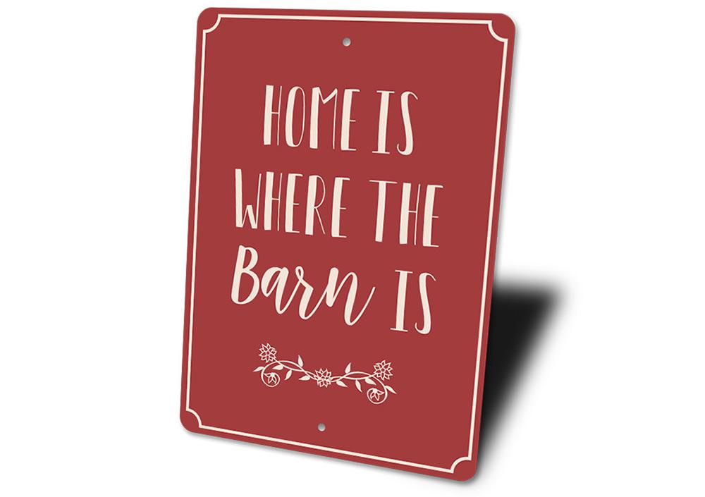 A decorative metal sign reading 'Home is Where the Barn is', showcasing a rustic design suitable for barns and farmhouses.