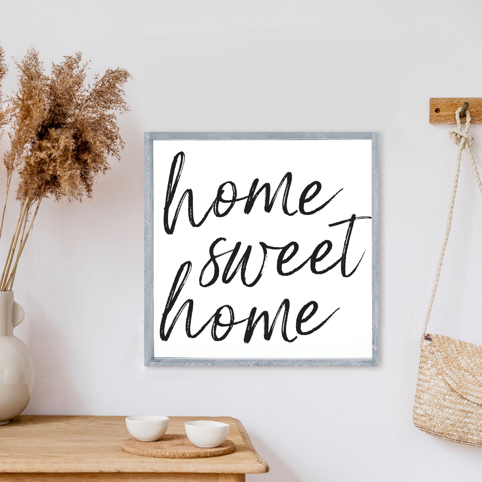 A charming Home Sweet Home Wood Sign, measuring 13x13 inches, featuring black waterproof text on a white background with a rustic wood frame.