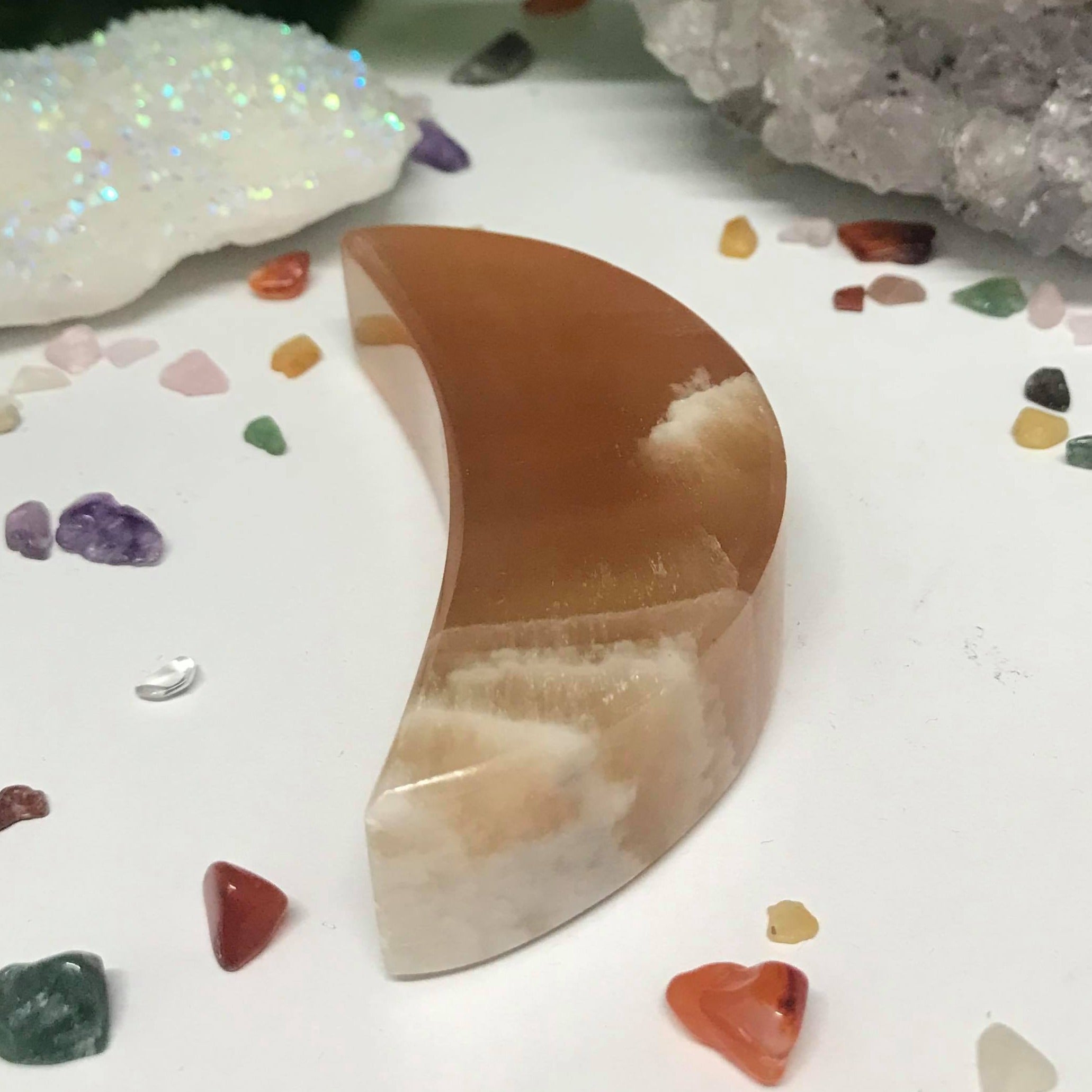 A beautiful Honey Calcite Crescent Moon crystal, showcasing its warm golden hues and smooth surface, perfect for healing and decoration.