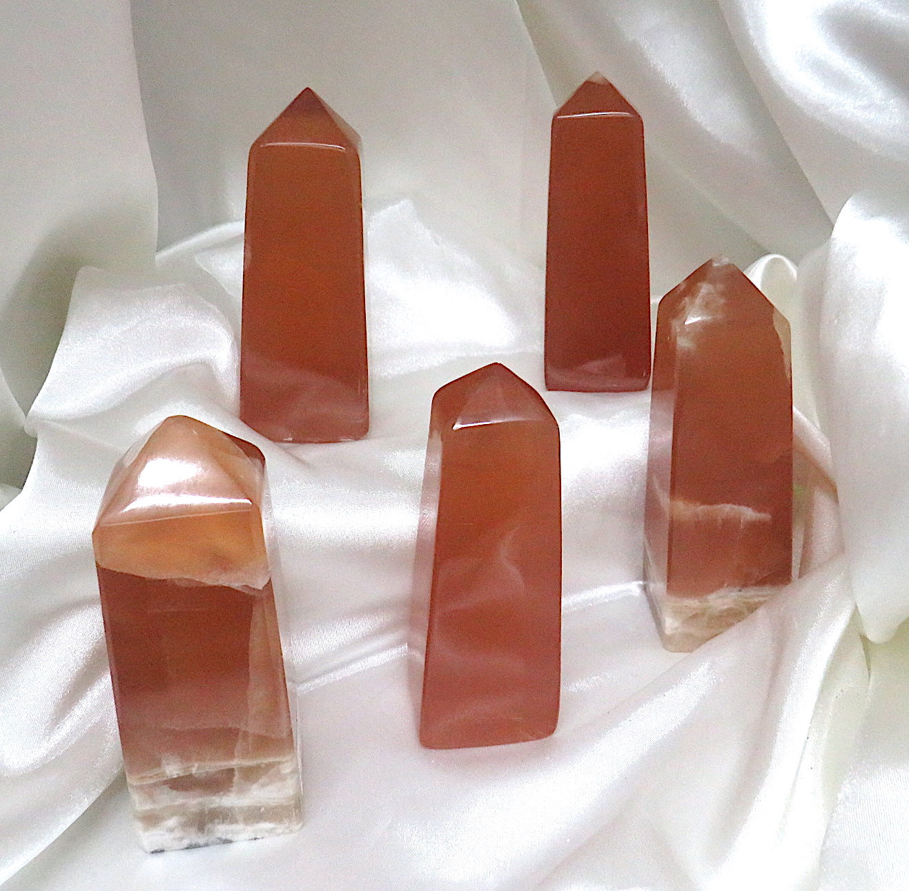 A beautifully hand-carved Honey Calcite Tower showcasing its vibrant golden hue and unique natural imperfections.