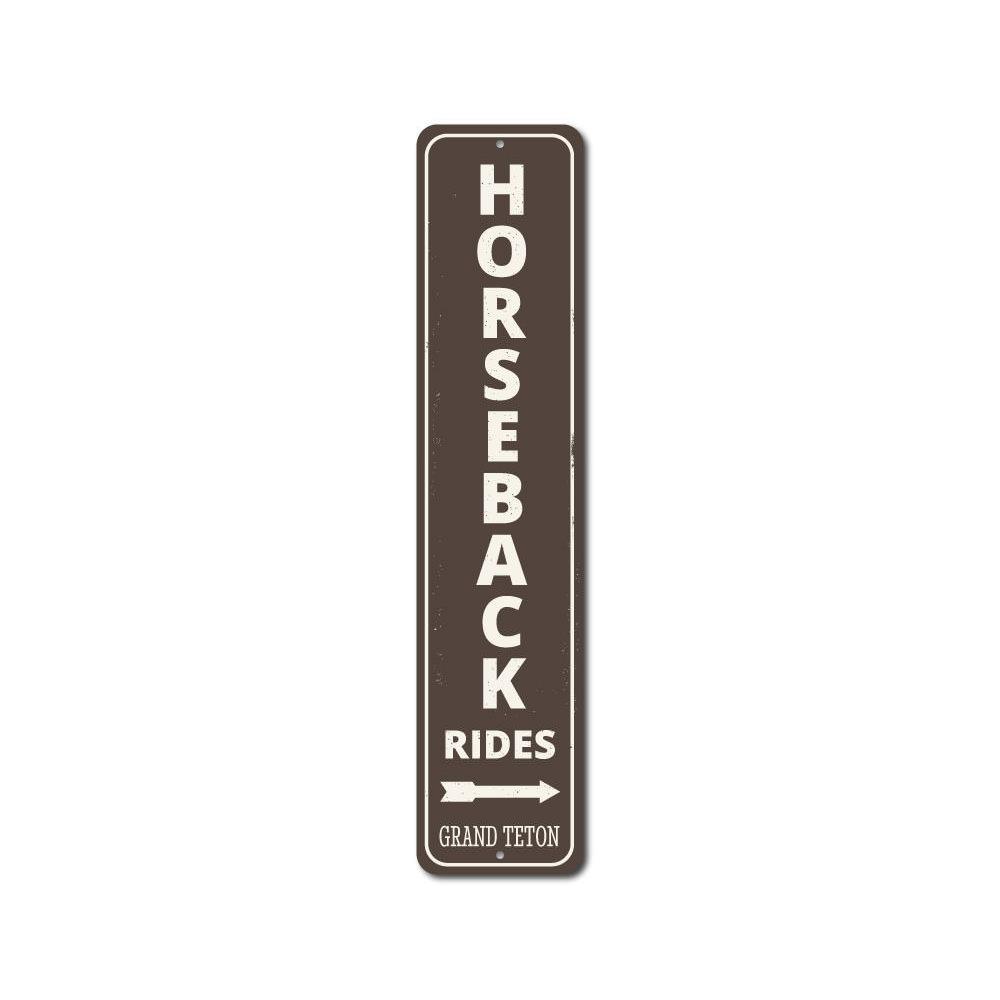 A decorative Horseback Rides Vertical Sign made of high-quality aluminum, showcasing a rustic design perfect for lakeside decor.