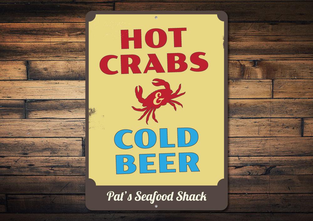 A vibrant metal sign featuring the phrase 'Hot Crabs and Cold Beer', perfect for beach houses and seafood restaurants.