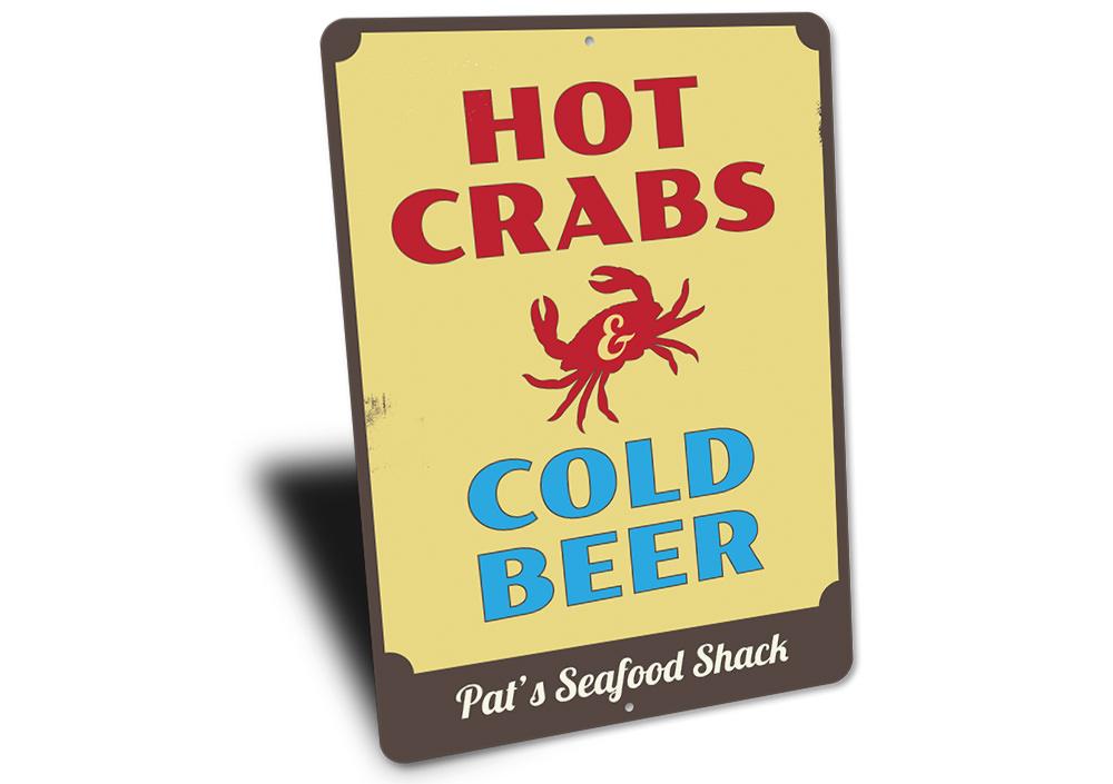 A vibrant metal sign featuring the phrase 'Hot Crabs and Cold Beer', perfect for beach houses and seafood restaurants.