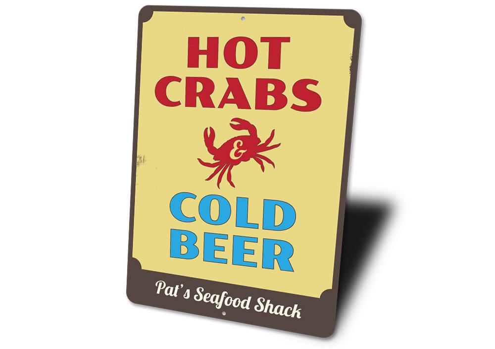 A vibrant metal sign featuring the phrase 'Hot Crabs and Cold Beer', perfect for beach houses and seafood restaurants.