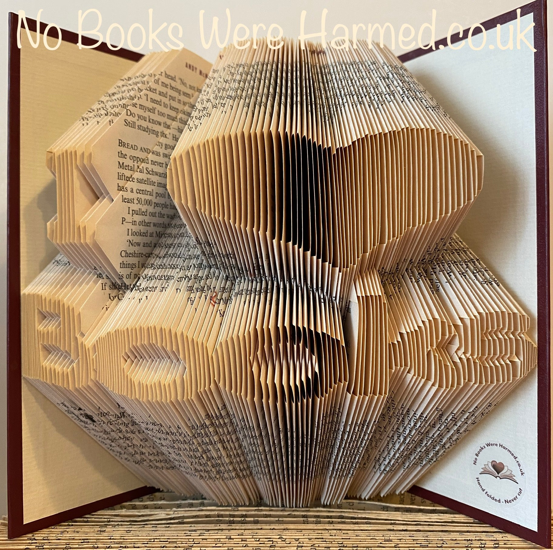 Handcrafted I ♥ Books art piece made from vintage book pages, showcasing intricate folds and unique design.