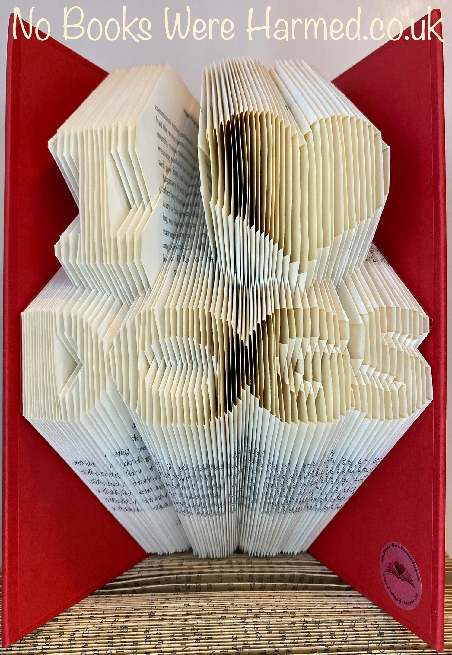 Handcrafted 'I ♥ DOGS' book art made from vintage book pages, showcasing intricate folds and unique design.