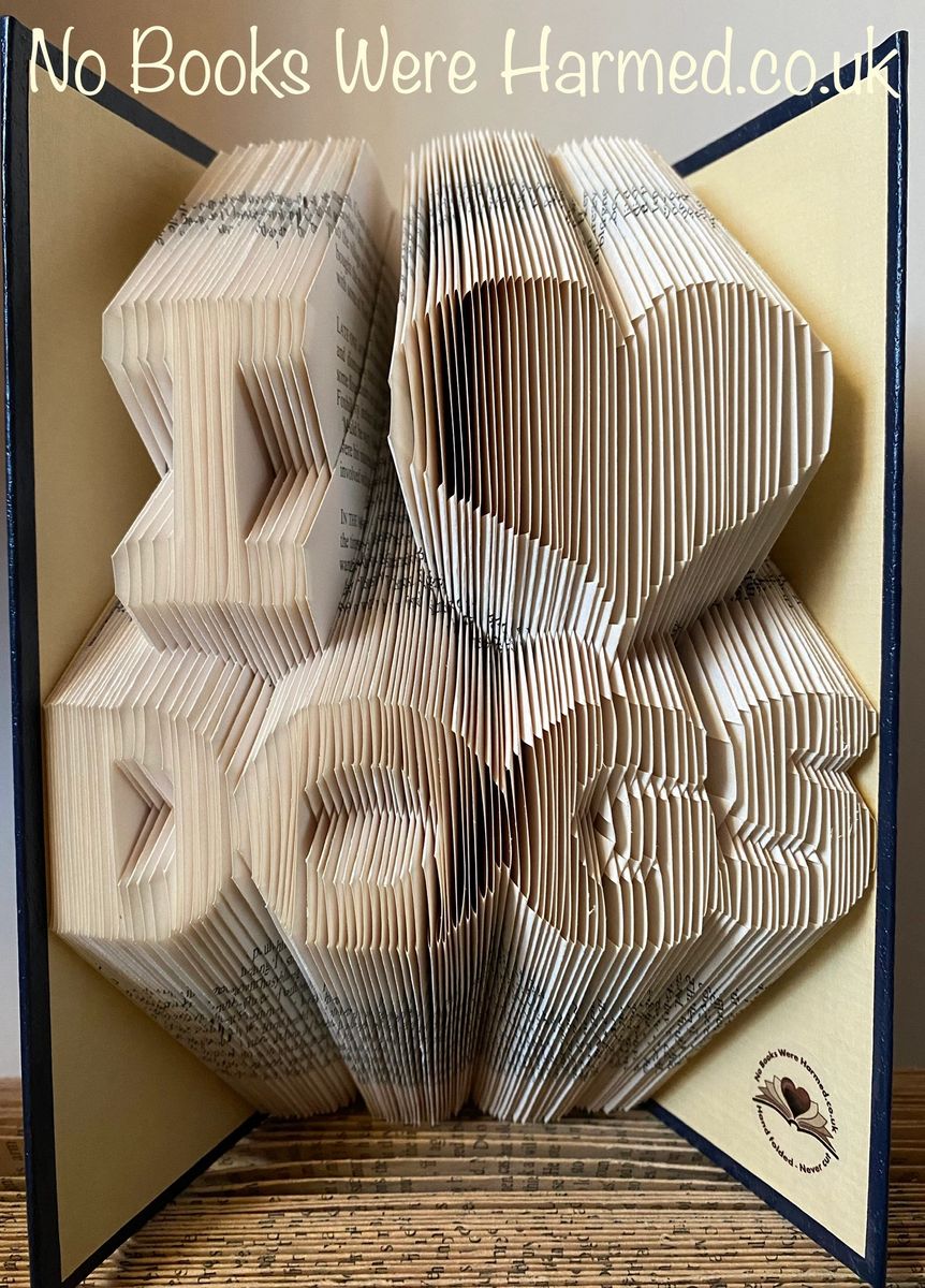 Handcrafted 'I ♥ DOGS' book art made from vintage book pages, showcasing intricate folds and unique design.