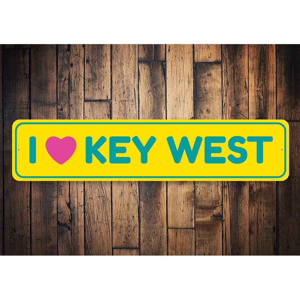 A decorative I Love Key West sign made of high-quality aluminum, featuring vibrant colors and a coastal design, perfect for beach-themed decor.