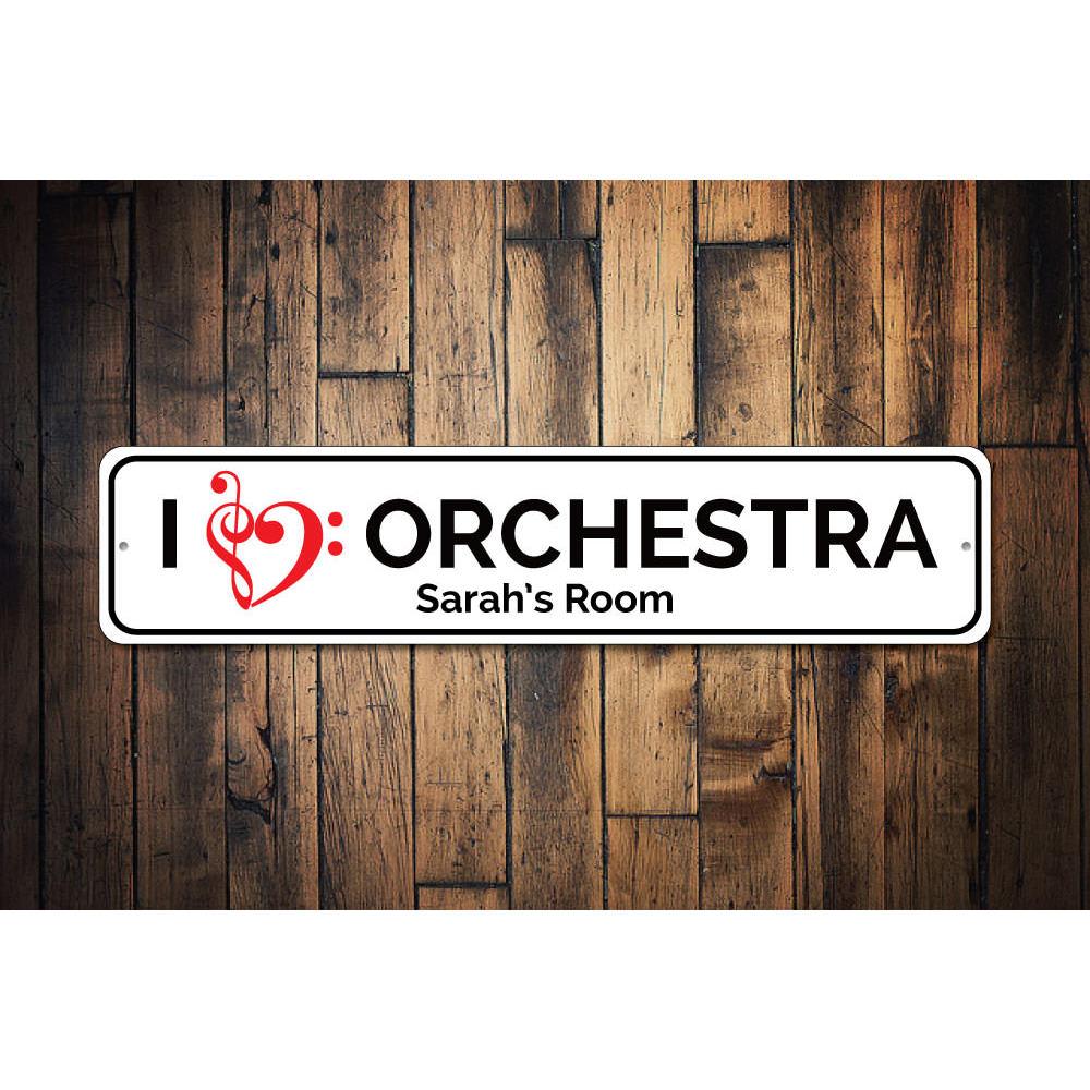 A decorative I Love Orchestra Sign made of high-quality aluminum, featuring vibrant colors and a musical theme, perfect for wall decor.