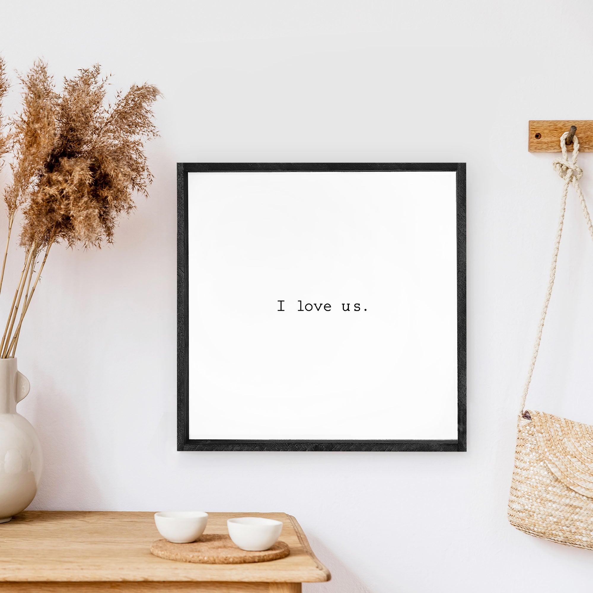 A beautifully crafted I Love Us Wood Sign, measuring 13x13 inches, featuring a black waterproof text on a white background with a wooden frame.