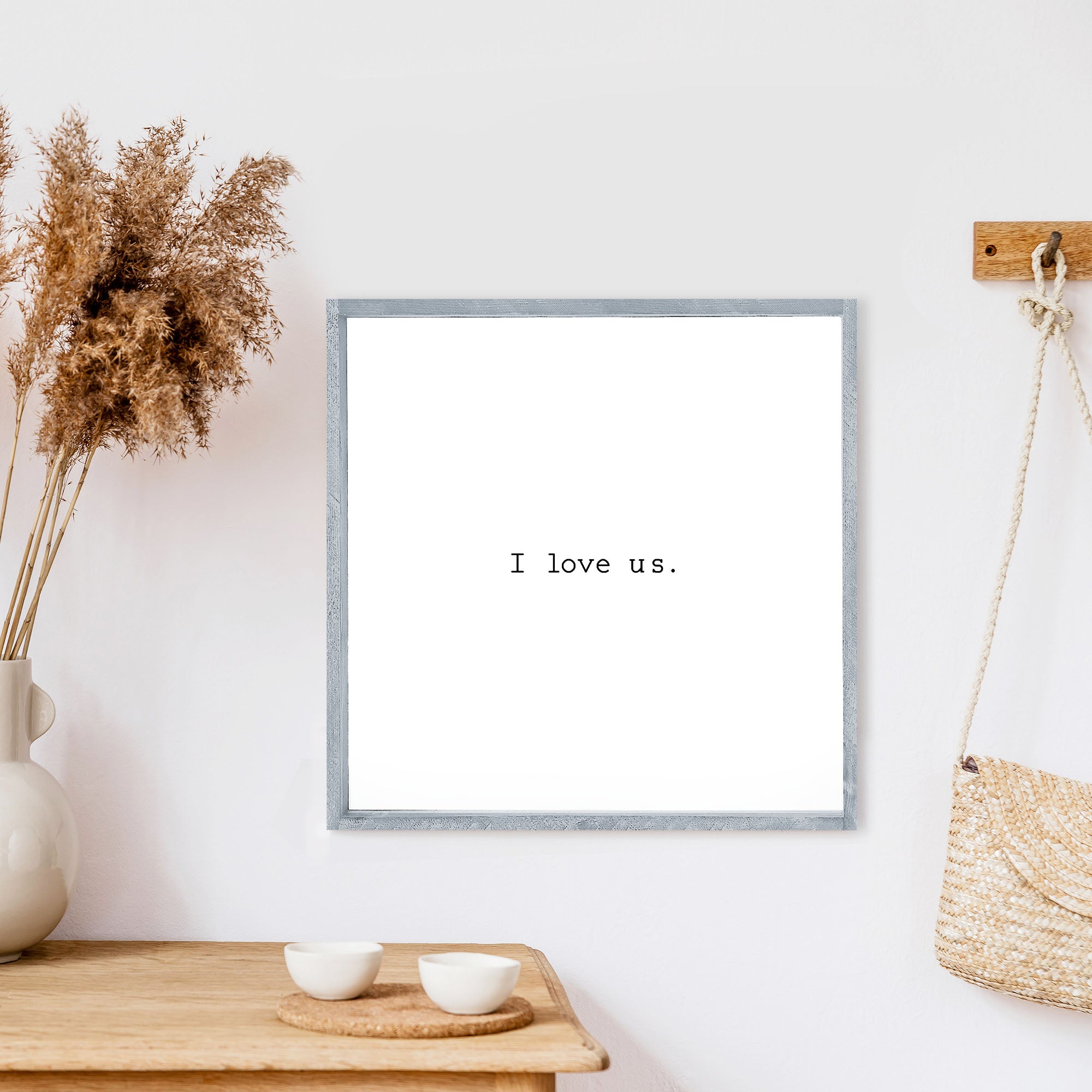 A beautifully crafted I Love Us Wood Sign, measuring 13x13 inches, featuring a black waterproof text on a white background with a wooden frame.