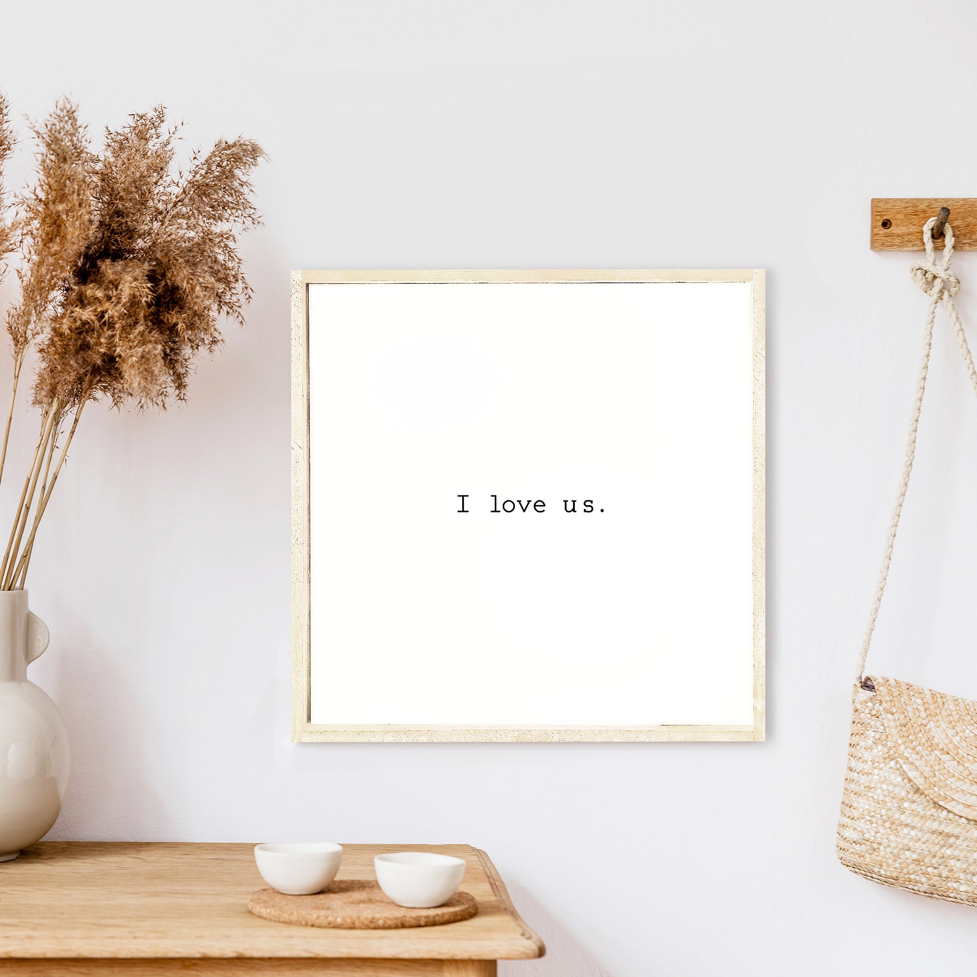 A beautifully crafted I Love Us Wood Sign, measuring 13x13 inches, featuring a black waterproof text on a white background with a wooden frame.