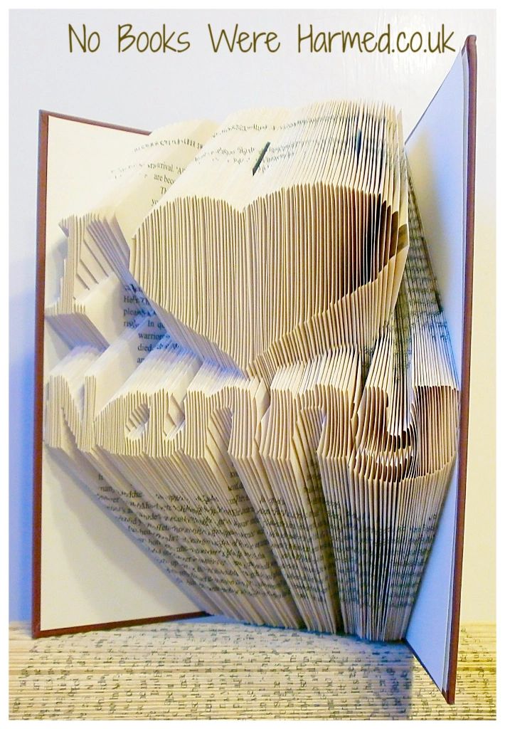 Handcrafted I ♥ Nanny book art made from vintage books, showcasing unique folded pages in various colors.