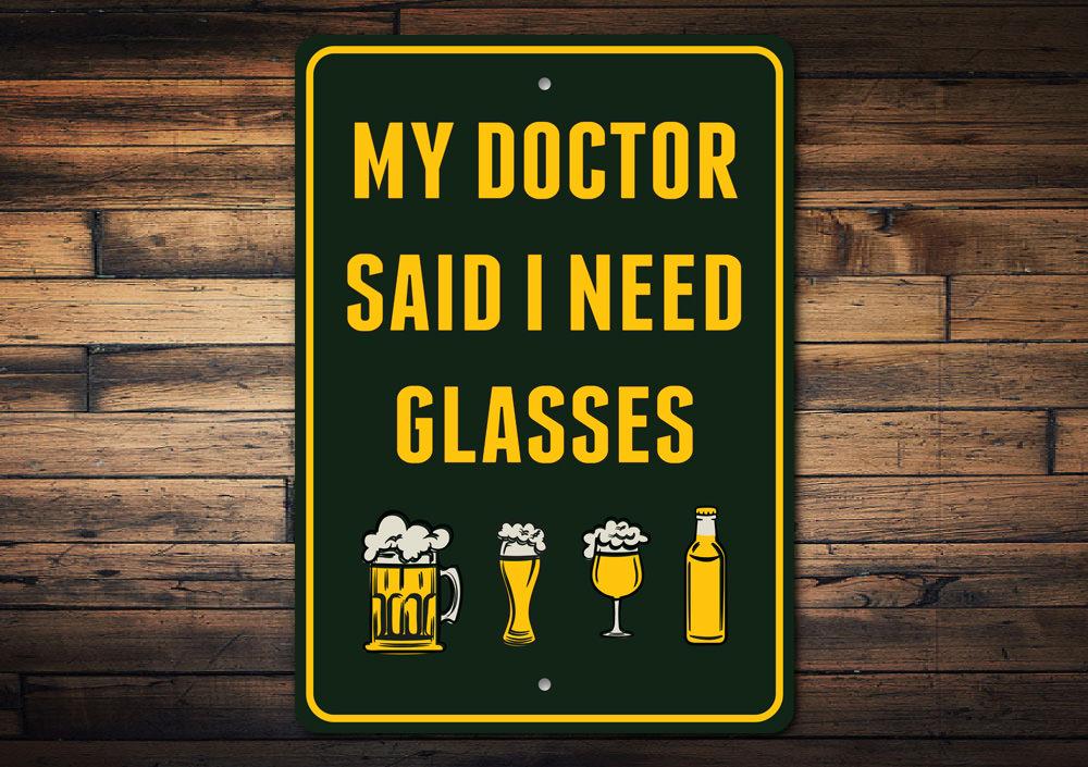 I Need Glasses Beer Sign made of durable aluminum, featuring humorous text and pre-drilled holes for easy mounting.